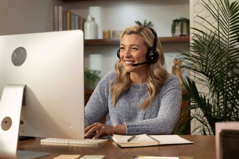 Rose, a 24/7 Virtual Receptionist, working hard at her computer.